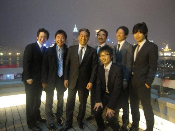PwC colleagues on a rooftop at night