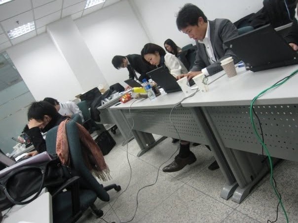 Training day at PwC, colleagues working on laptops